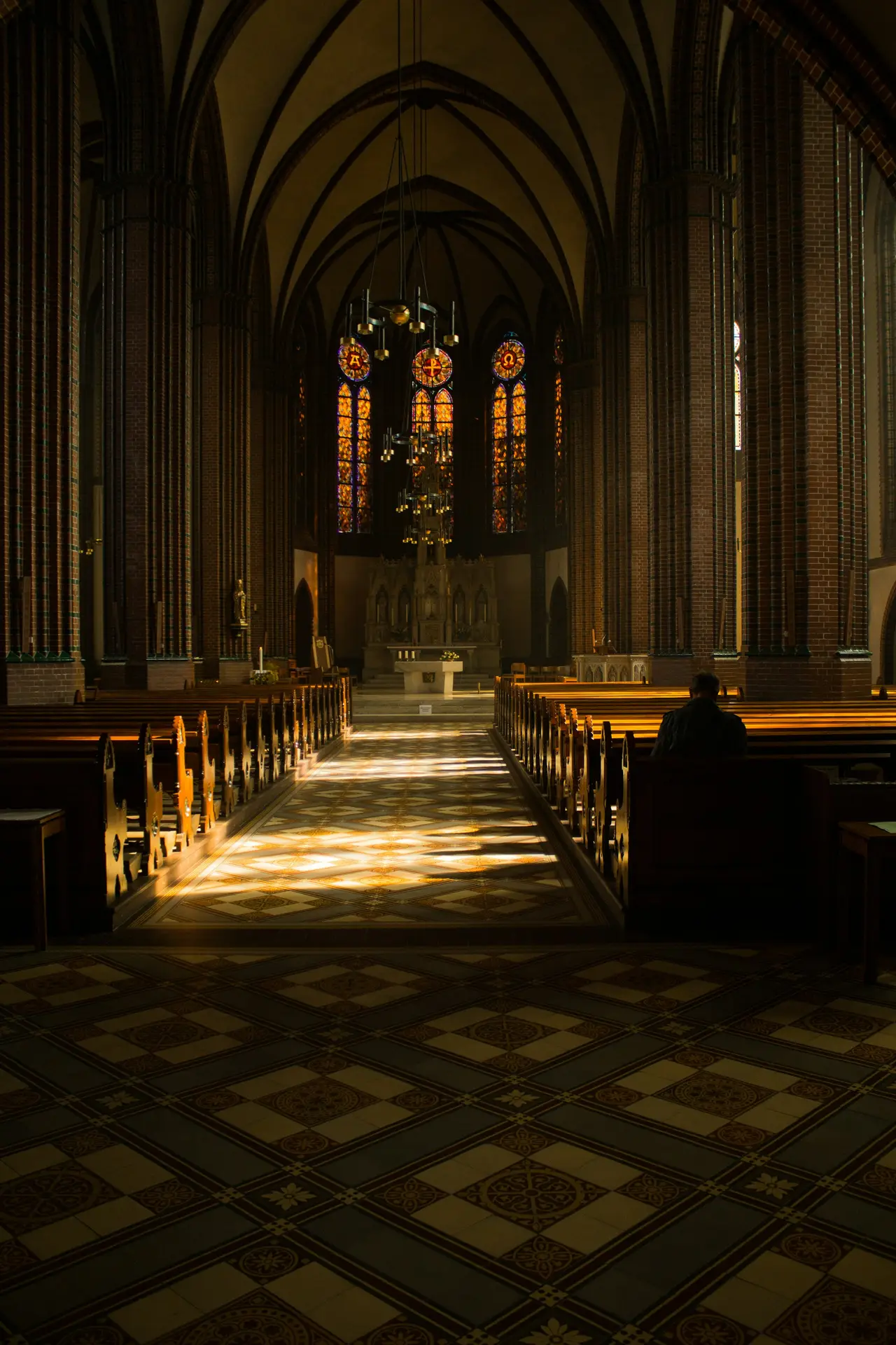 Sunlight falling across wooden pews in a quiet sanctuary